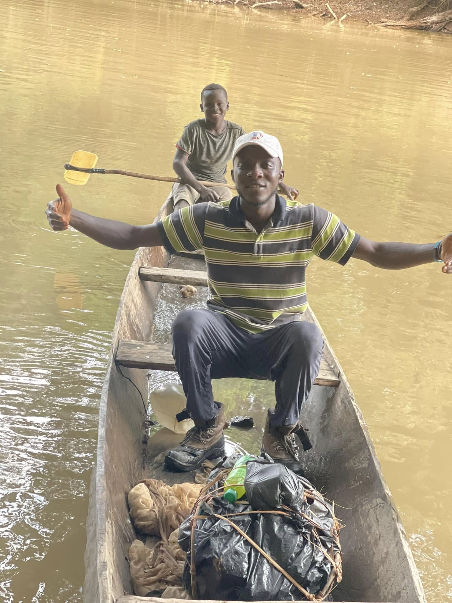 Community members in a canoe on the river, symbolizing environmental stewardship and connection to nature